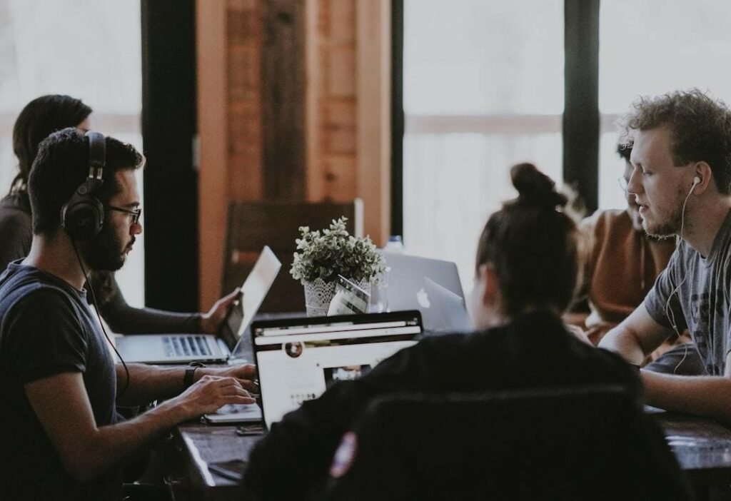 A group of team members is gathered around a table, conducting market research.